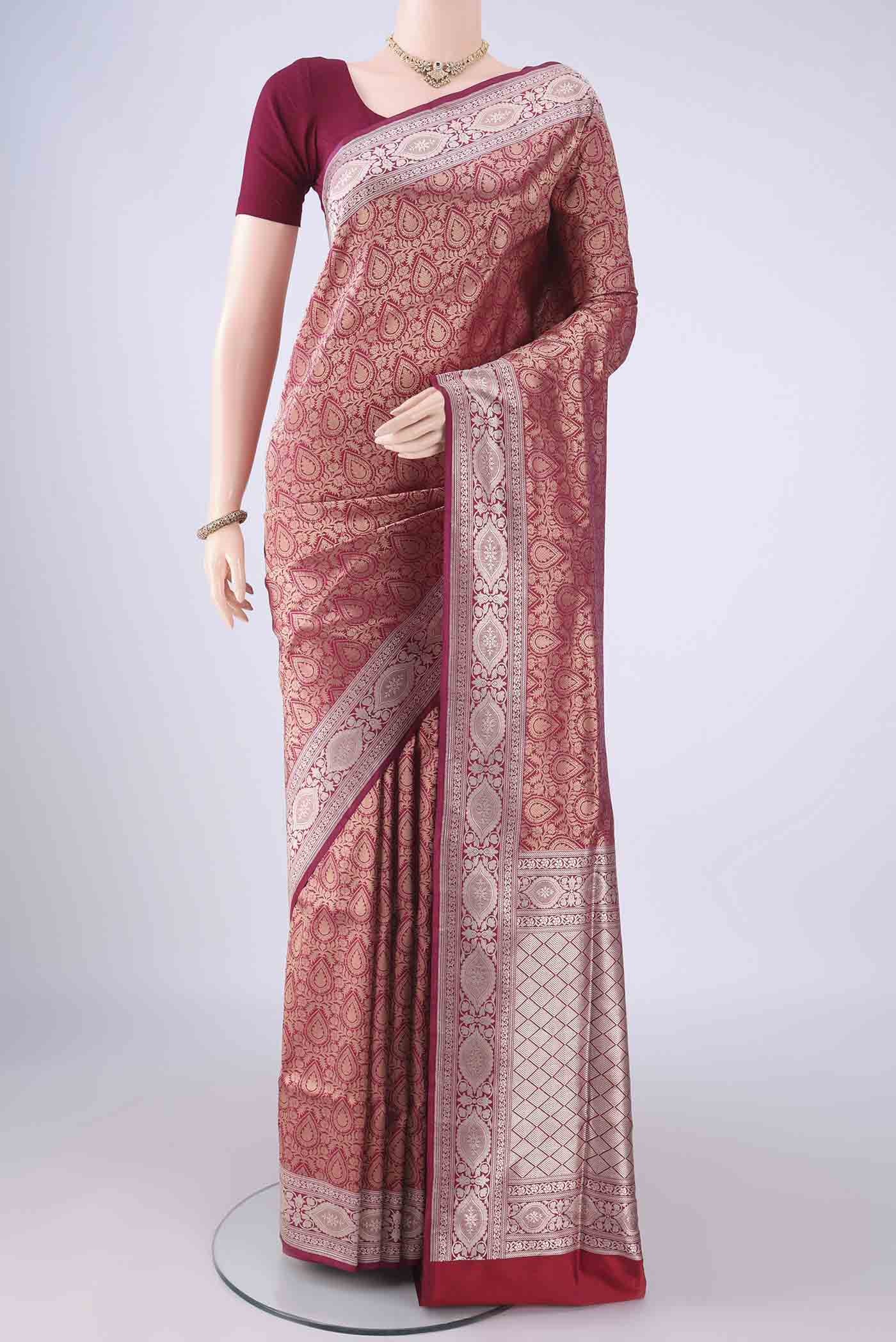 Maroon Banarasi Silk Saree with Zari Brocade on the body and Zari Border.  displayed on a mannequin