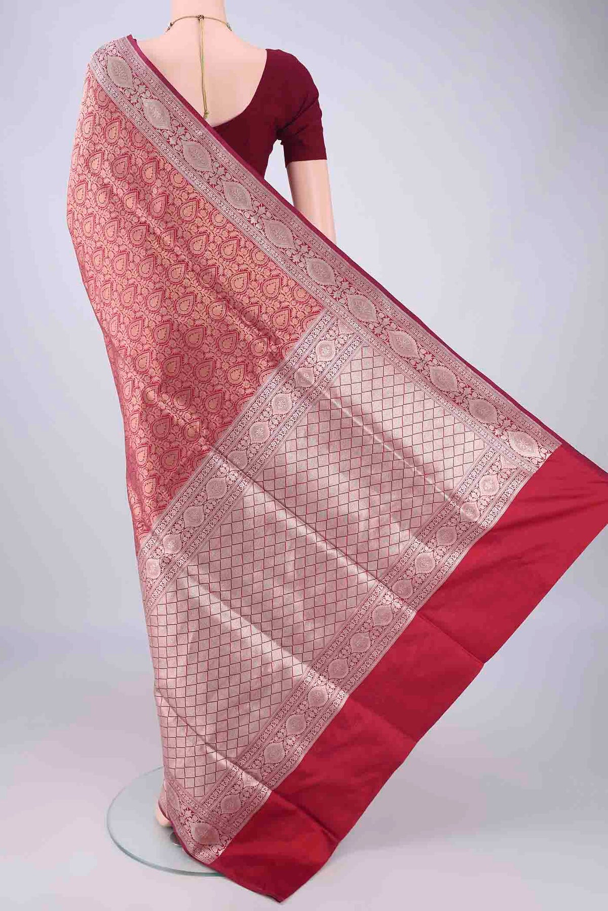 Flat view of Maroon Banarasi Silk Saree with Zari Brocade on the body and Zari Border. 
