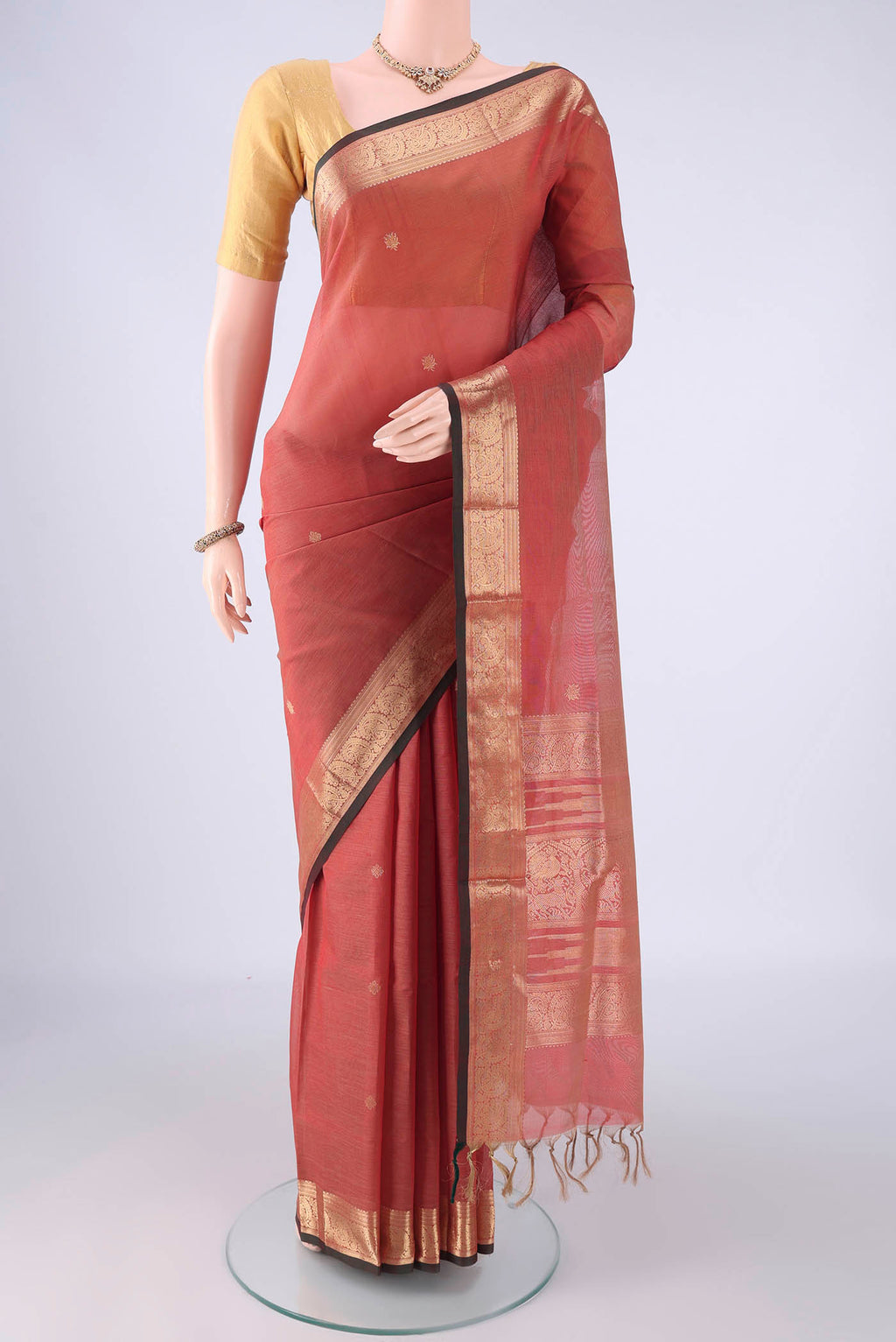 Coral Coimbatore Silk Cotton Saree with Zari Butta on the body and Zari Border.  displayed on a mannequin