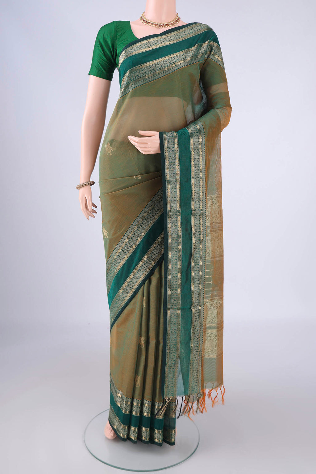 Light Green Dual Tone Coimbatore Silk Cotton Saree with Zari Butta on the body and Zari And Thread Border.  displayed on a mannequin