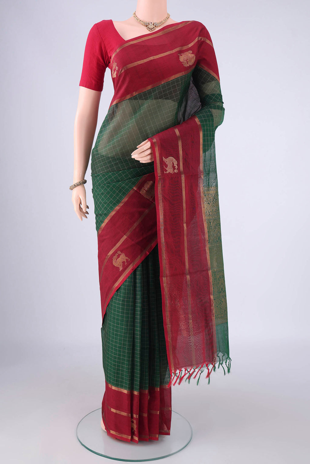 Bottle Green Coimbatore Silk Cotton Saree with Checked design on the body and Zari Border.  displayed on a mannequin