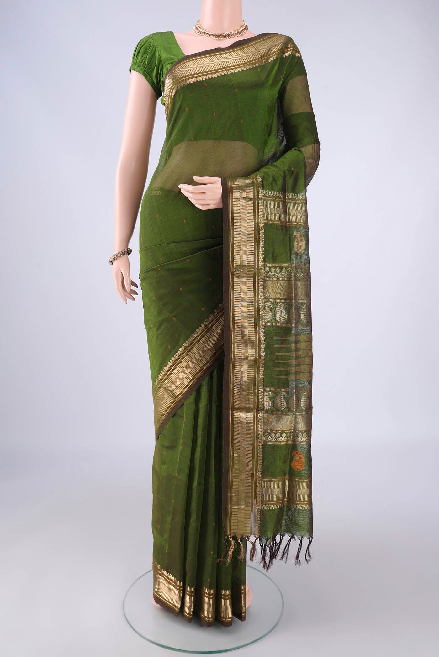 Mehandi Green Coimbatore Silk Cotton Saree with Thread Butta on the body and Zari Border.  displayed on a mannequin