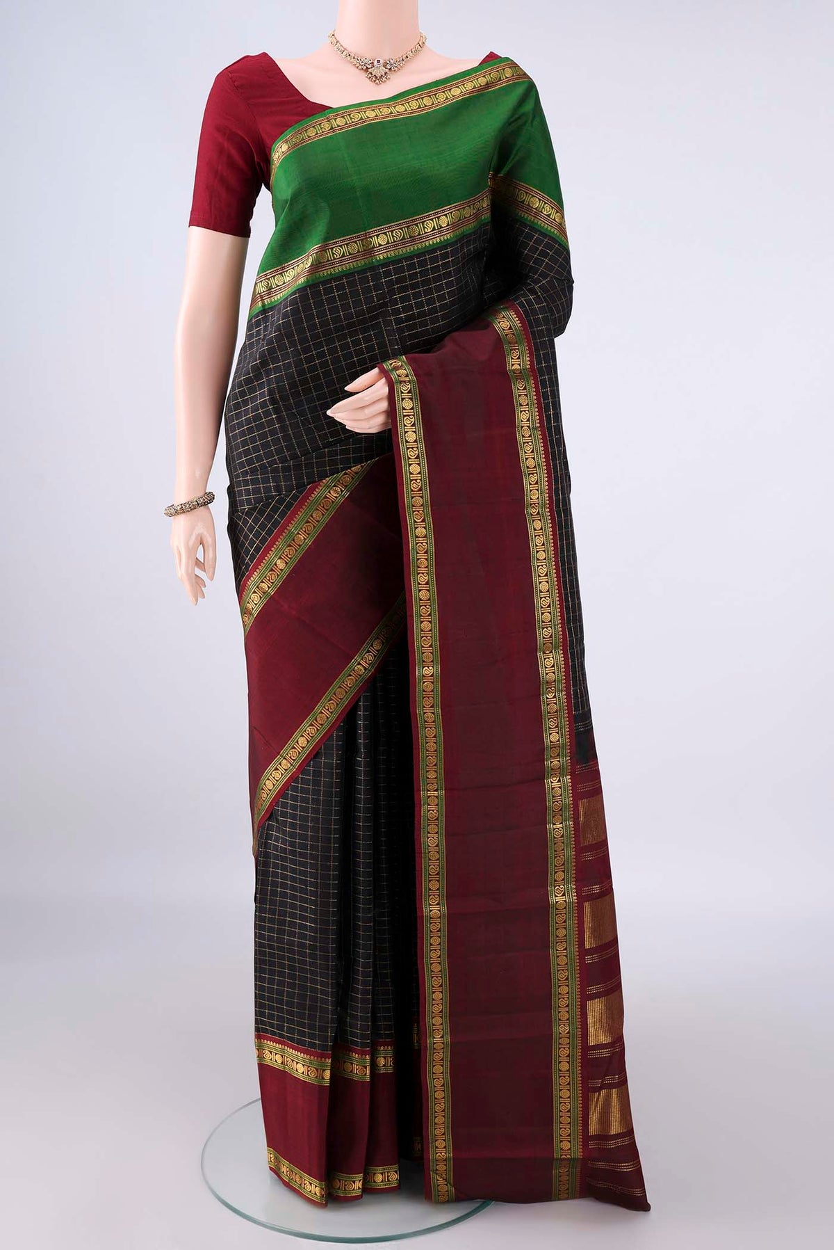 Pure Silk Black Kanchipuram Saree with Checked design on the body and Ganga Jamuna Border.  displayed on a mannequin