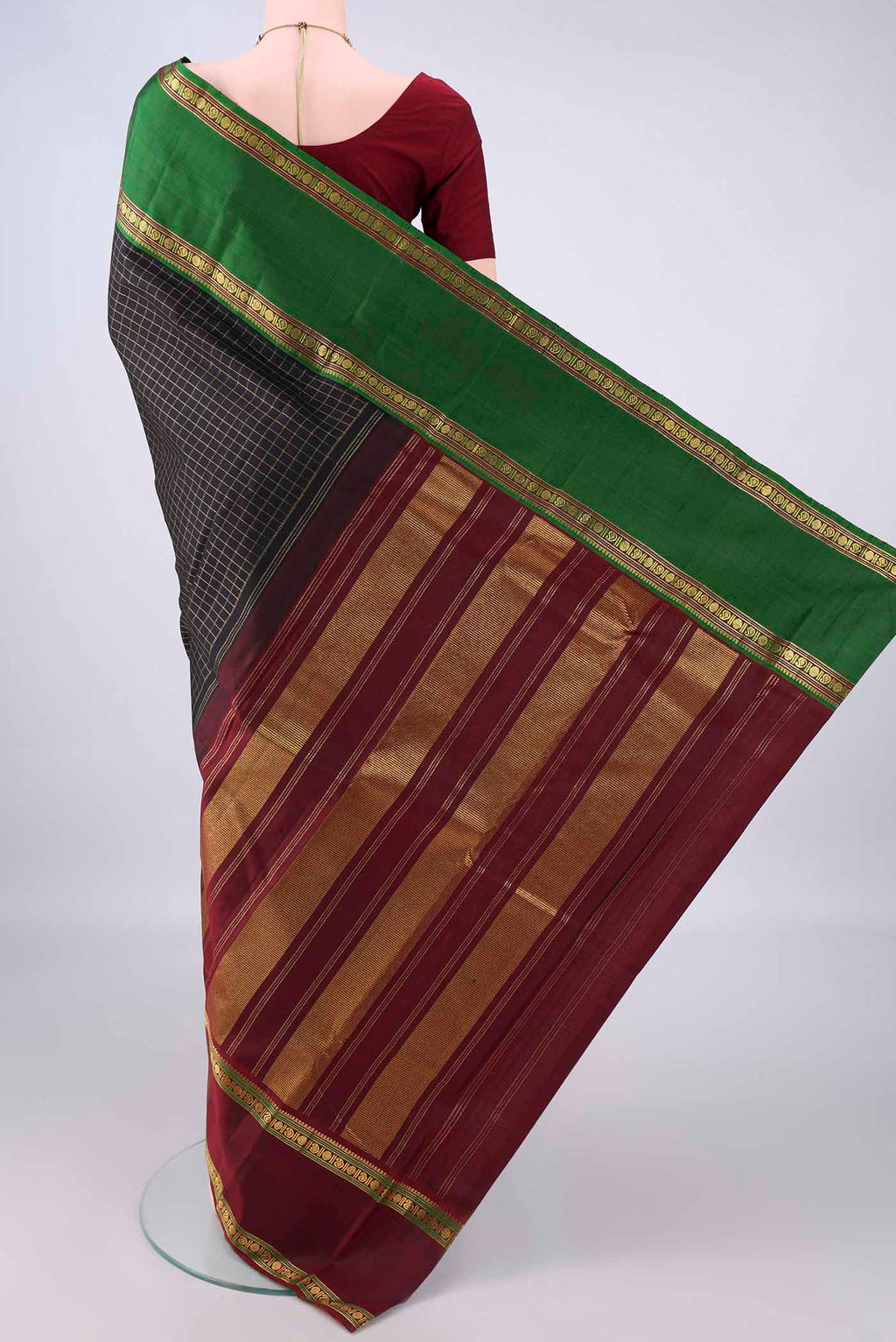 Flat view of Pure Silk Black Kanchipuram Saree with Checked design on the body and Ganga Jamuna Border. 