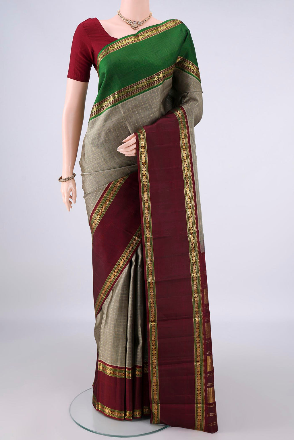 Pure Silk Grey Kanchipuram Saree with Checked design on the body and Ganga Jamuna Border.  displayed on a mannequin