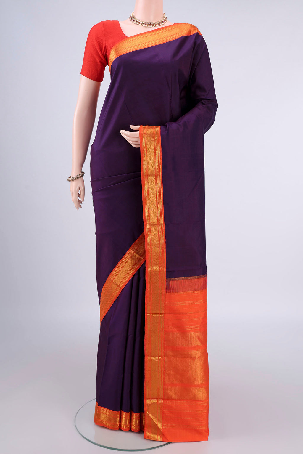 Pure Silk Purple Kanjivaram Saree with Plain Body and Zari Border.  displayed on a mannequin