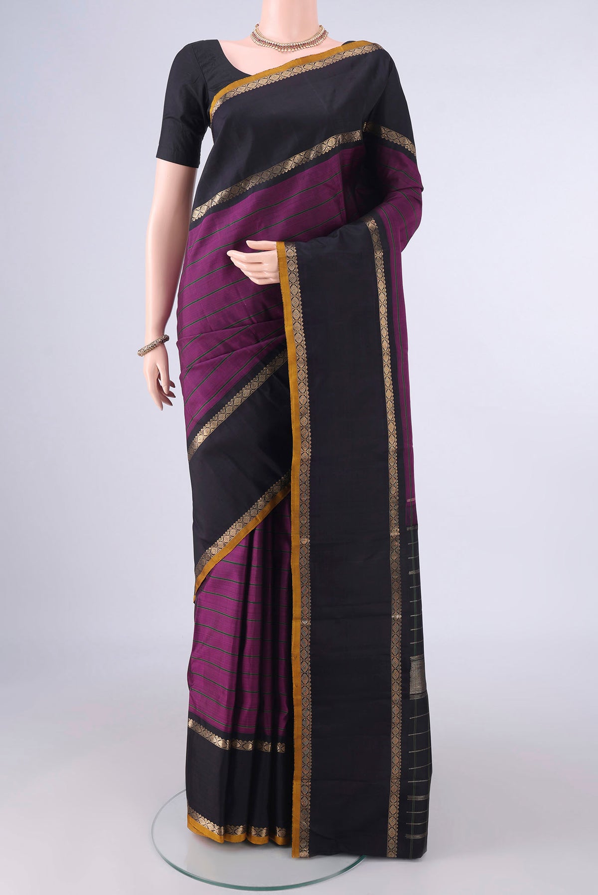 Pure Silk Purple Kanchipuram Saree with Stripes on the body and Zari Border.  displayed on a mannequin