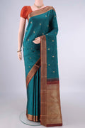Pure Silk Teal Kanjivaram Saree with Thread Butta on the body and Thread Border.  displayed on a mannequin