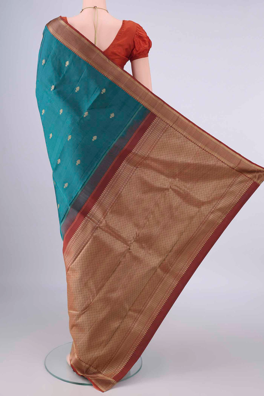 Flat view of Pure Silk Teal Kanjivaram Saree with Thread Butta on the body and Thread Border. 