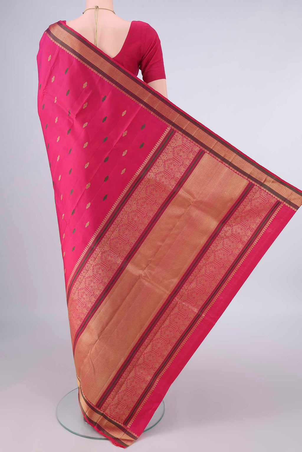 Flat view of Pure Silk Rani Pink Kanjivaram Saree with Thread Butta on the body and Thread Border. 