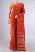 Pure Silk Rust Kanjivaram Saree with Thread Butta on the body and Thin Zari Line.  displayed on a mannequin