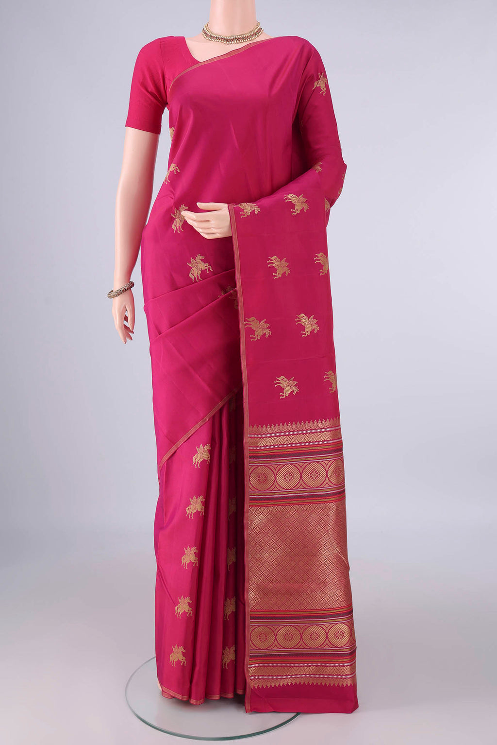 Pure Silk Rani Pink Kanjivaram Saree with Thread Butta on the body and Plain Border.  displayed on a mannequin