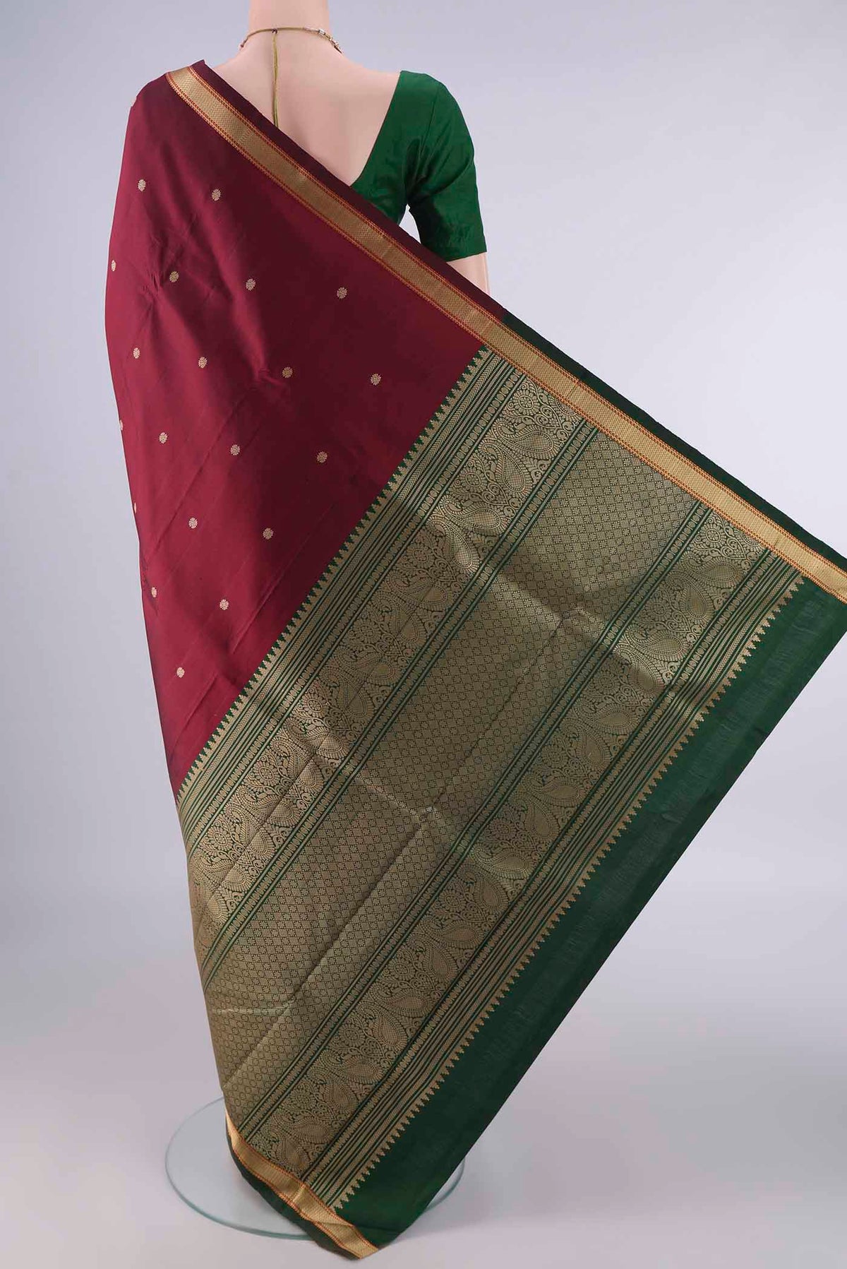 Flat view of Pure Silk Maroon Kanjivaram Saree with Thread Butta on the body and Thread Border. 