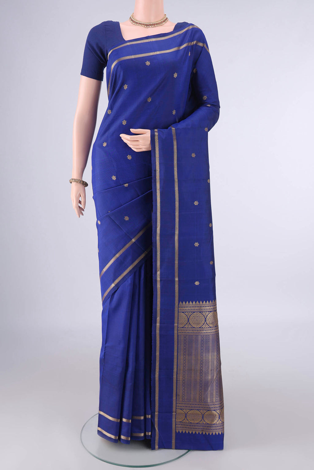 Pure Silk Royal Blue Kanjivaram Saree with Thread Butta on the body and Thread Border.  displayed on a mannequin