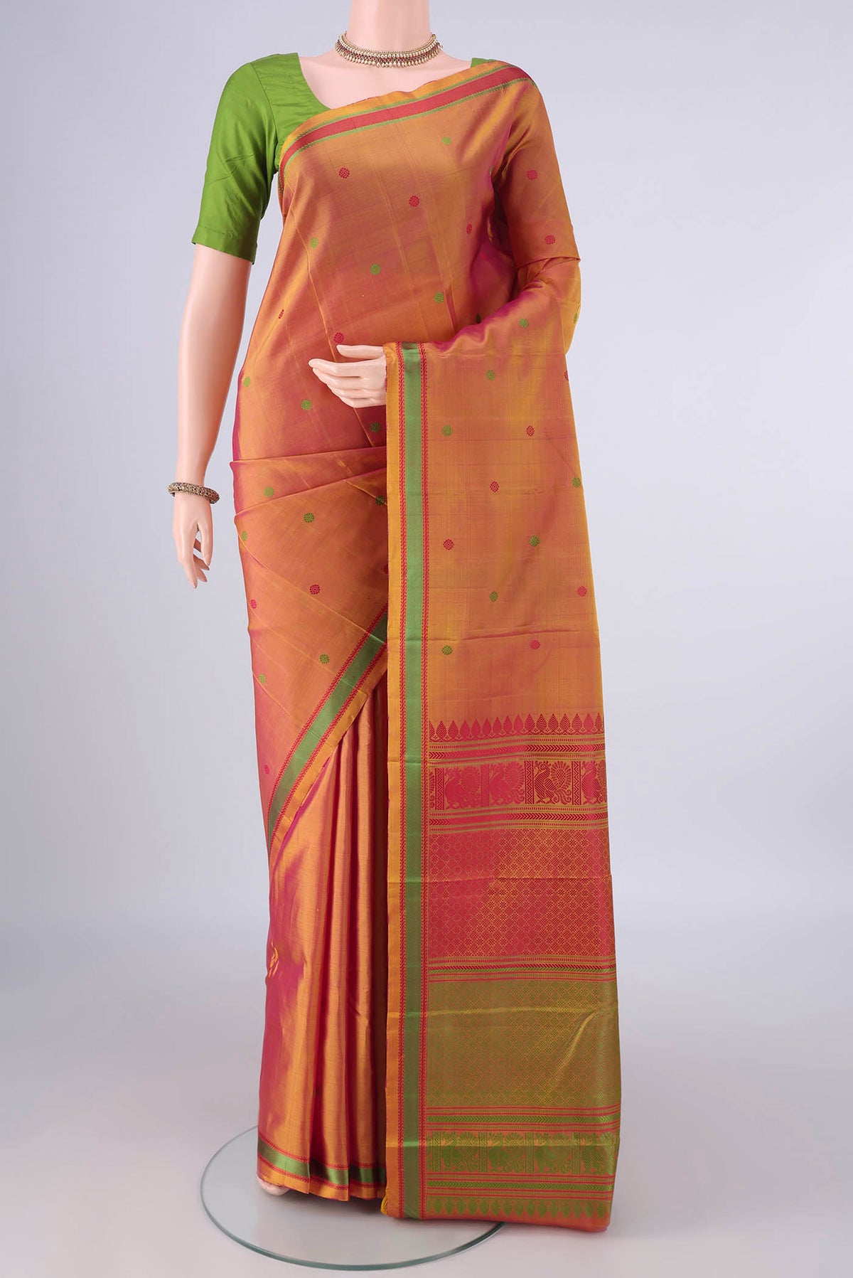 Pure Silk Pinkish Yellow Dual Tone Kanjivaram Saree with Thread Butta on the body and Thread Border.  displayed on a mannequin