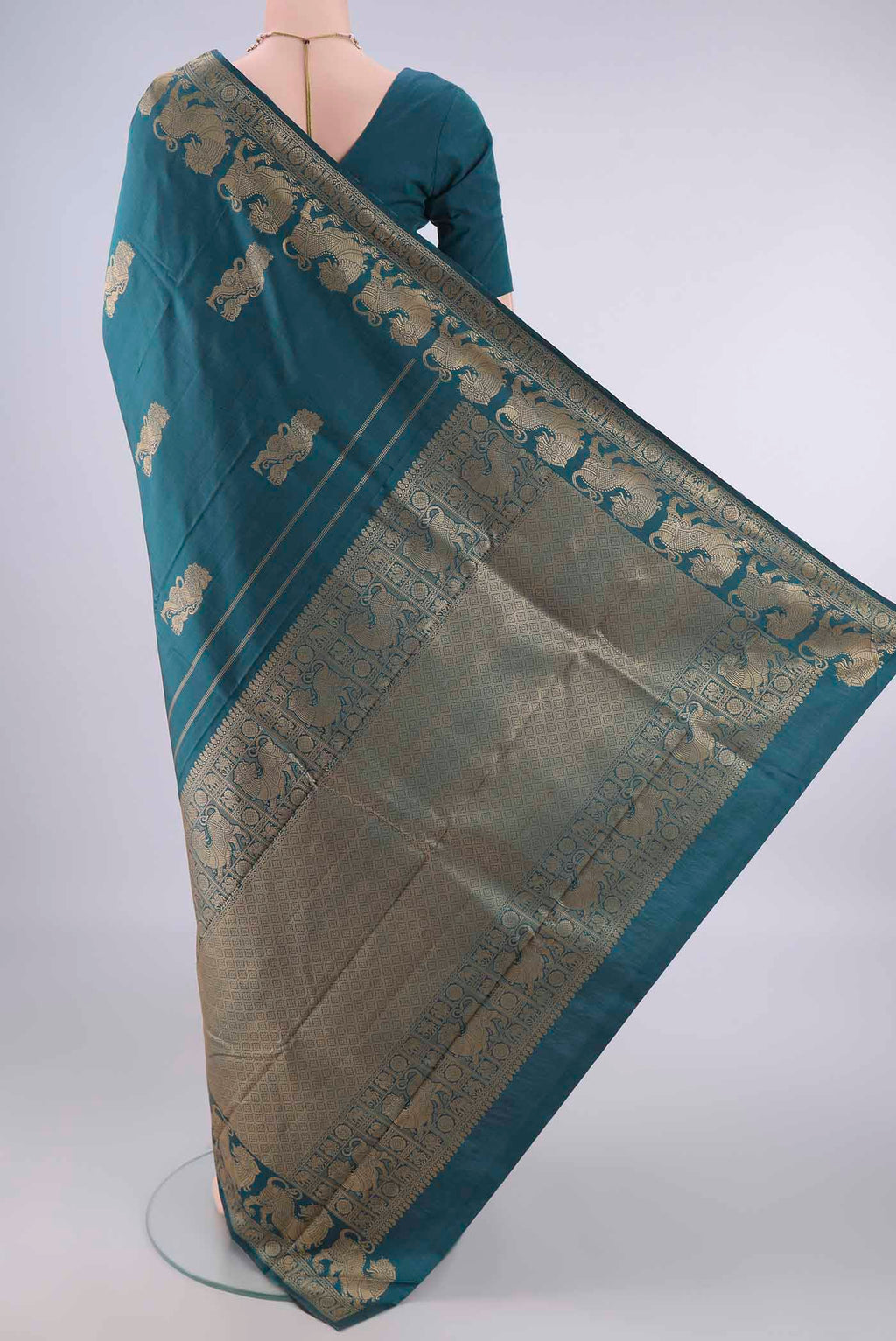 Flat view of Pure Silk Teal Kanjivaram Saree with Thread Butta on the body and Thread Border. 