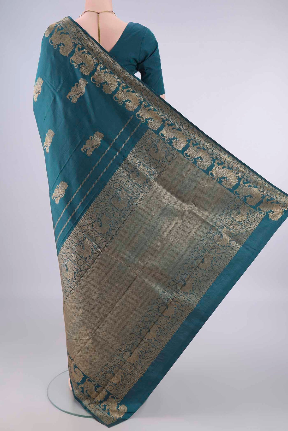 Flat view of Pure Silk Teal Kanjivaram Saree with Thread Butta on the body and Thread Border. 