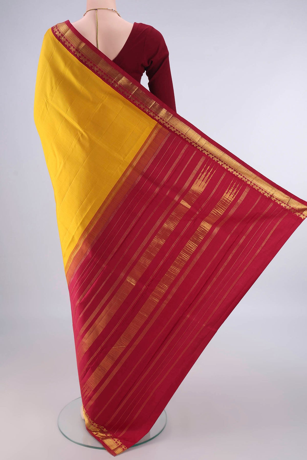 Flat view of Pure Silk Yellow Kanjivaram Saree with Plain Body and Zari Border. 