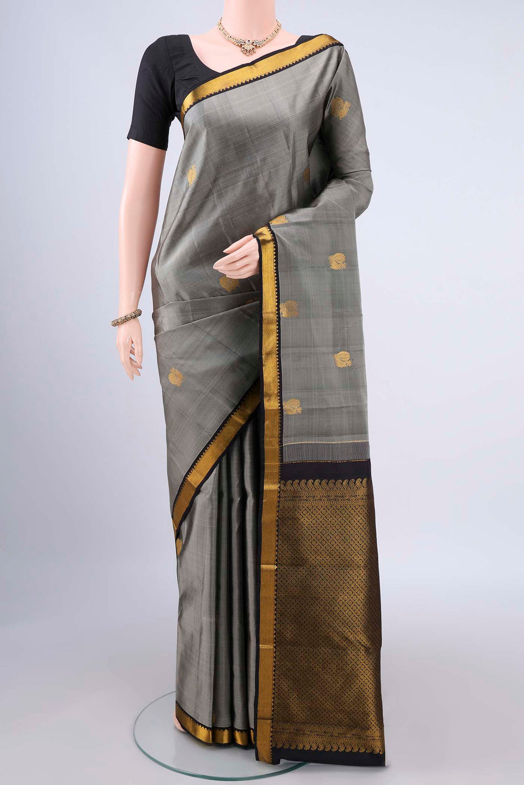 Pure Silk Grey Kanchipuram Saree with Zari Butta on the body and Zari Border.  displayed on a mannequin