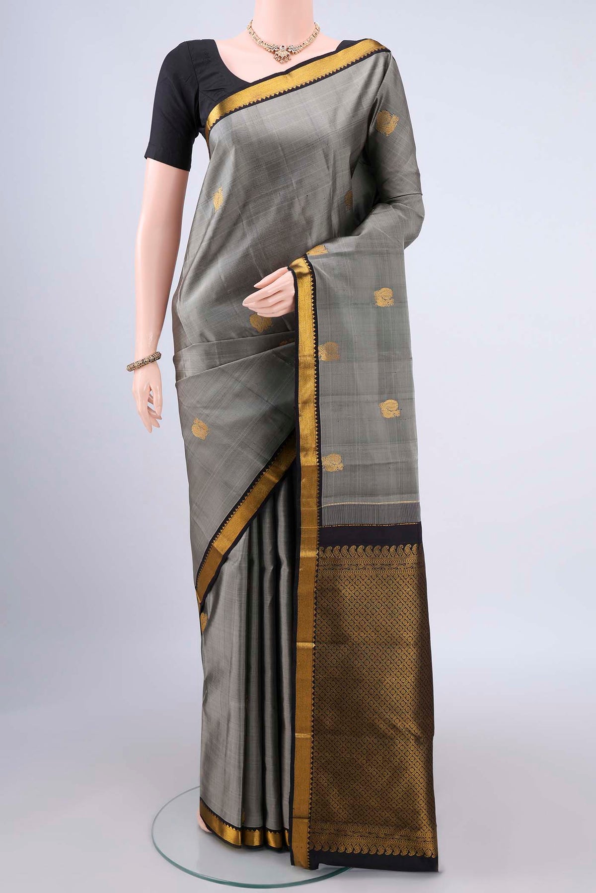 Pure Silk Grey Kanchipuram Saree with Zari Butta on the body and Zari Border.  displayed on a mannequin