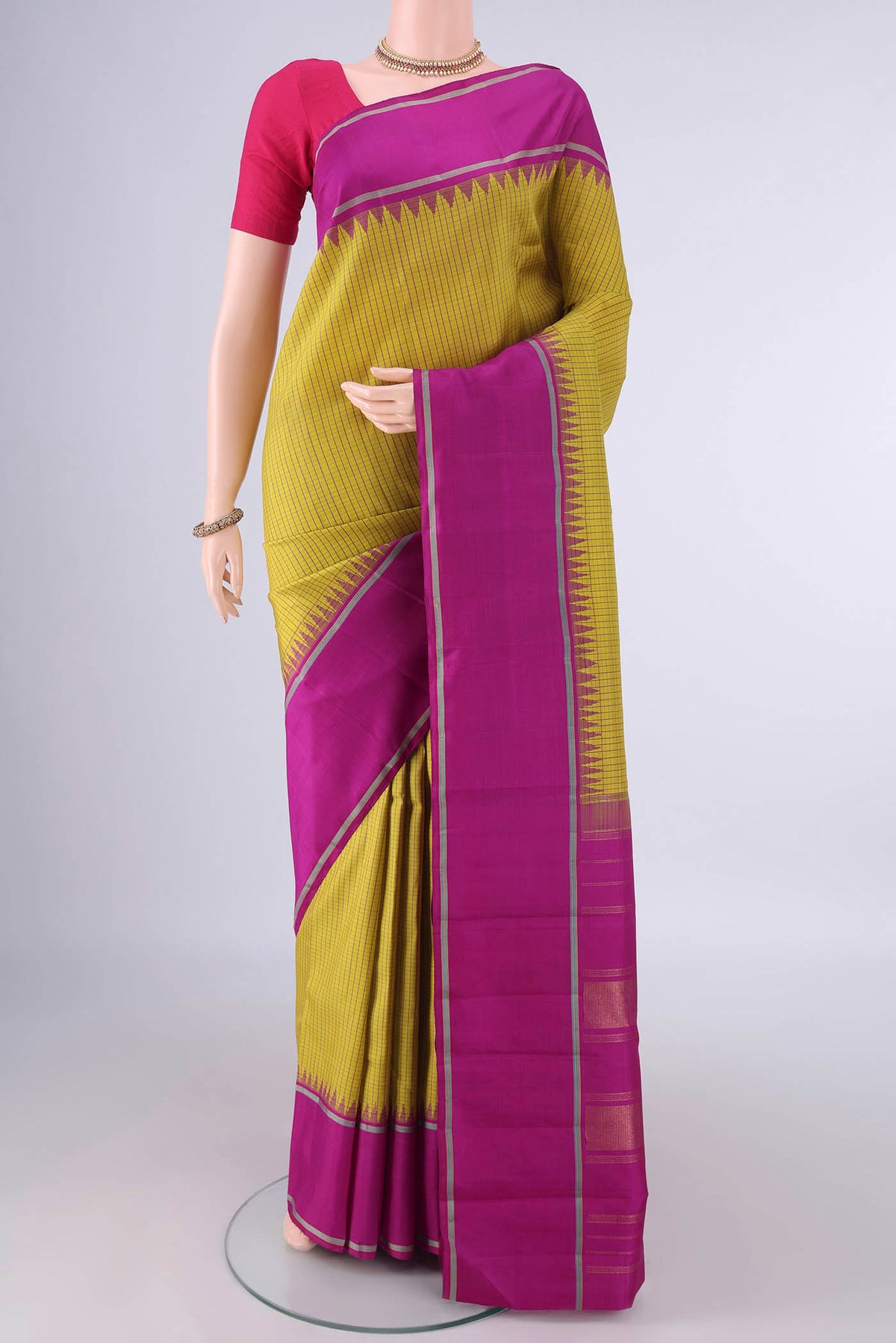 Pure Silk Pure Zari Mustard Kanjivaram Saree with Checked design on the body and Plain Border.  displayed on a mannequin