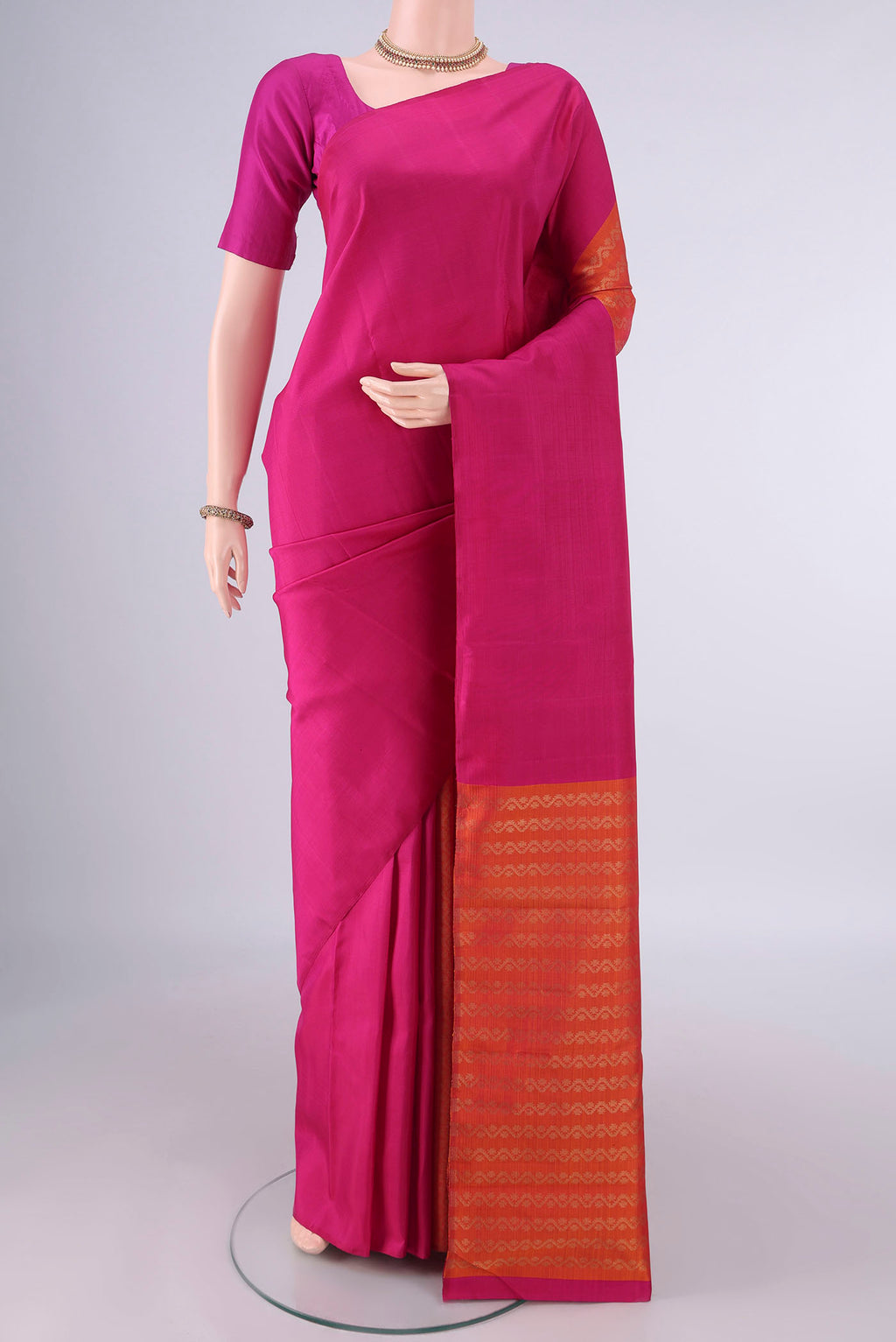 Pure Silk Rani Pink Kanchipuram Saree with Partli on the body and Without Border.  displayed on a mannequin