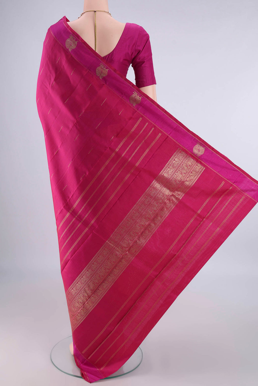Flat view of Pure Silk Pure Zari Rani Pink Kanchipuram Saree with Zari Butta on the body and Zari Border. 