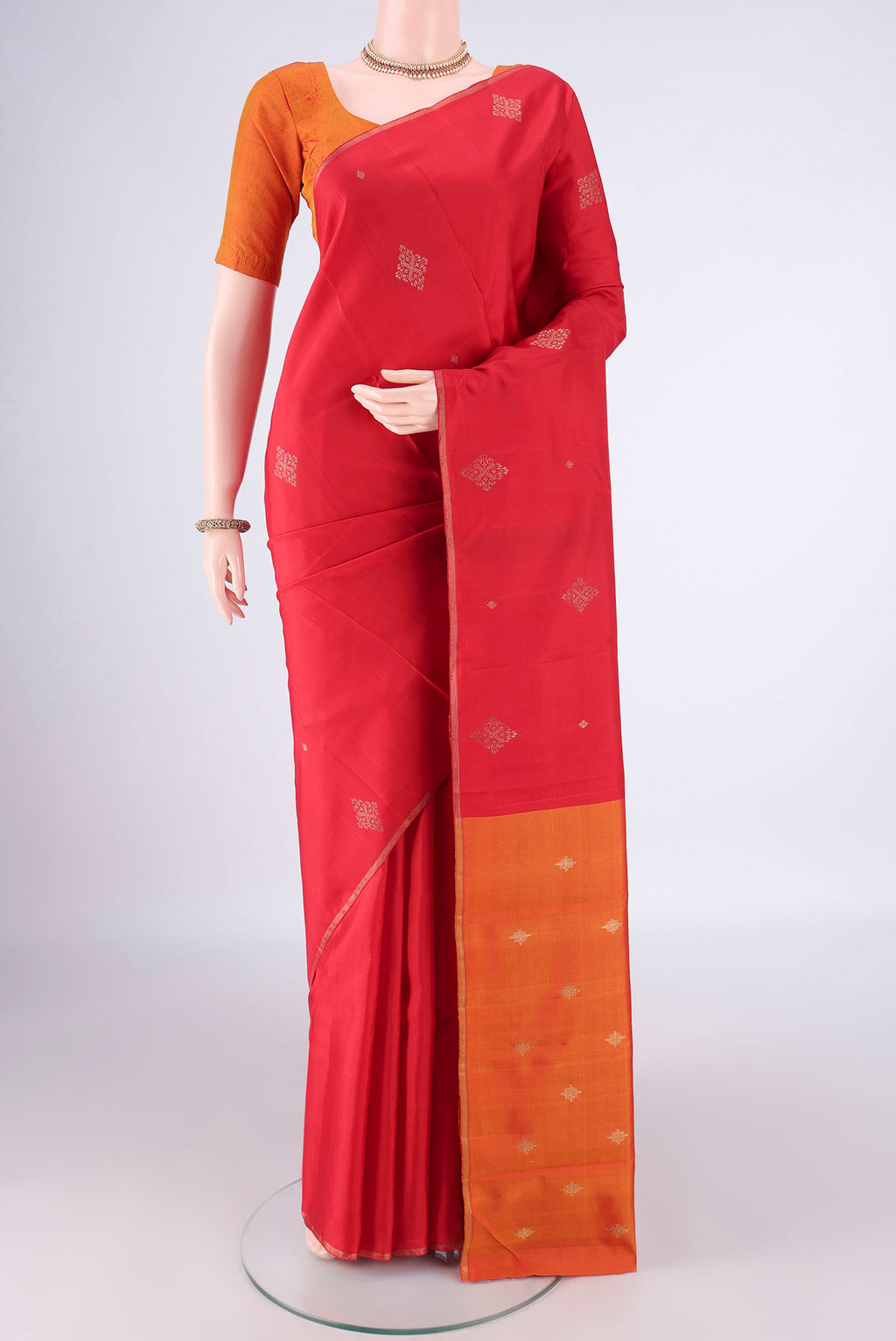 Pure Silk Pure Zari Red Kanchipuram Saree with Zari Butta on the body and Plain Border.  displayed on a mannequin