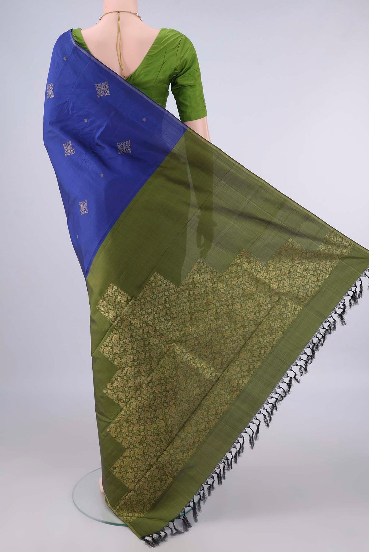 Flat view of Pure Silk Blue Kanchipuram Saree with Zari Butta on the body and Thin Zari Line. 