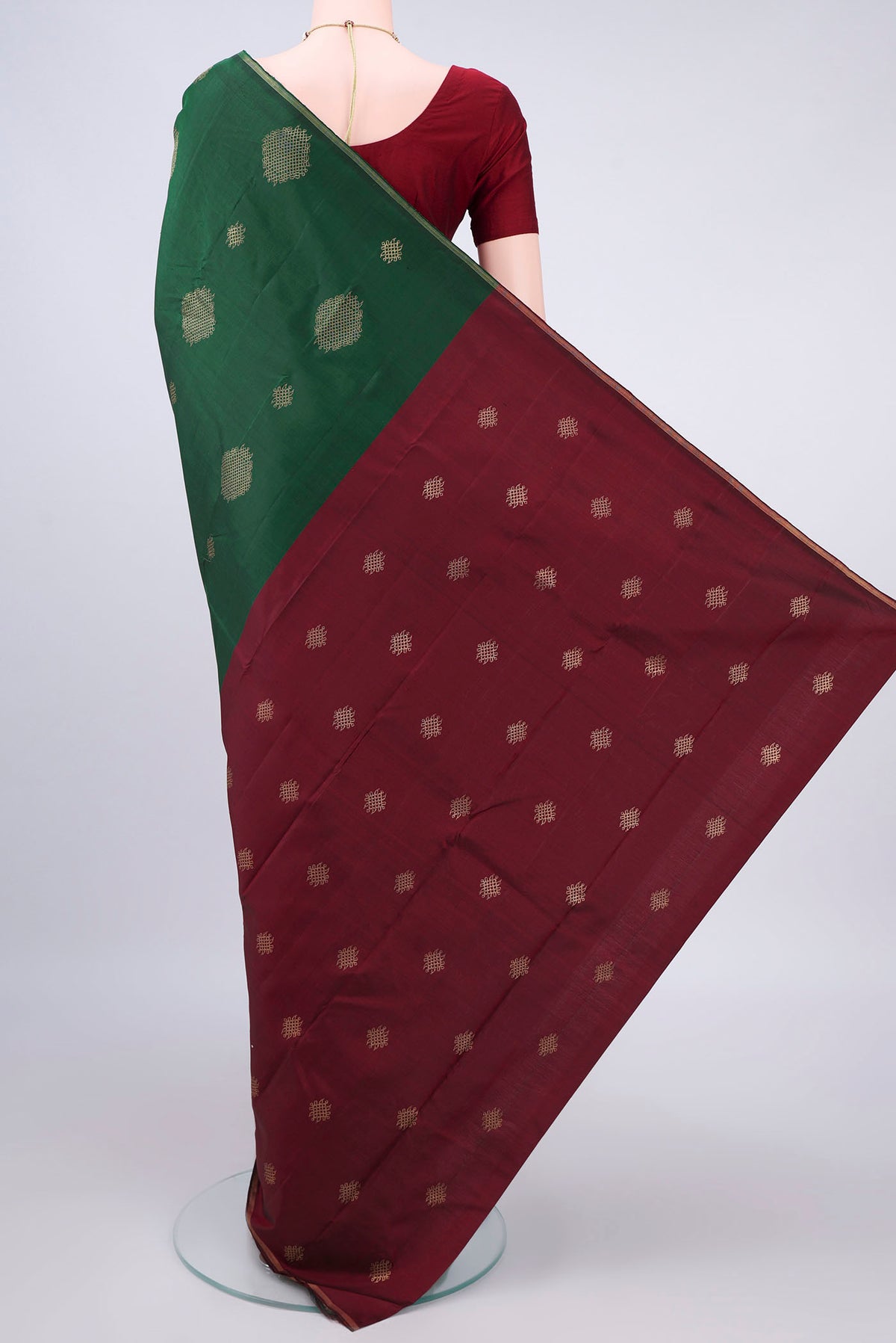 Flat view of Pure Silk Pure Zari Bottle Green Kanchipuram Saree with Zari Butta on the body and Zari Border. 