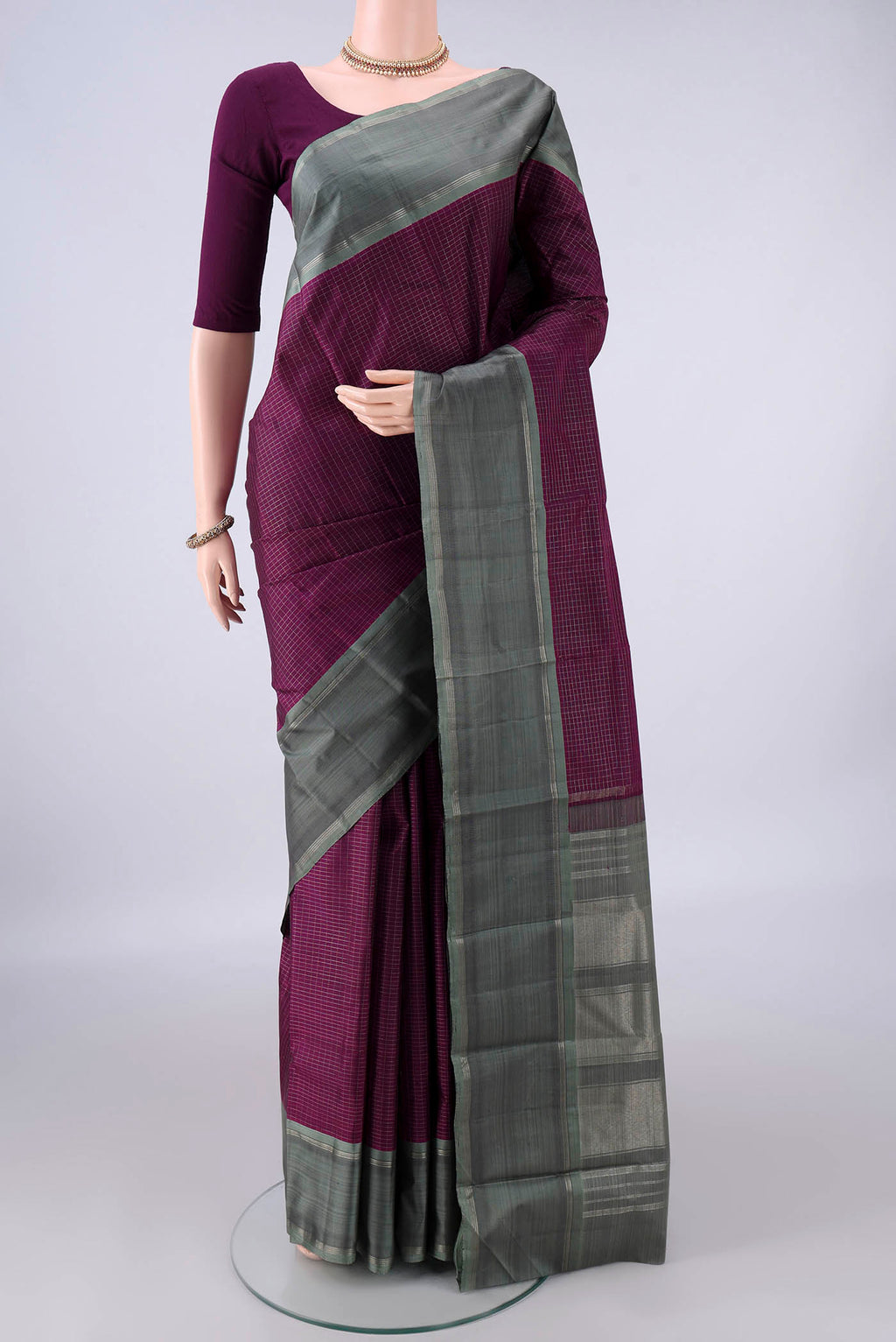 Pure Silk Purple Kanchipuram Saree with Checked design on the body and Zari Border.  displayed on a mannequin