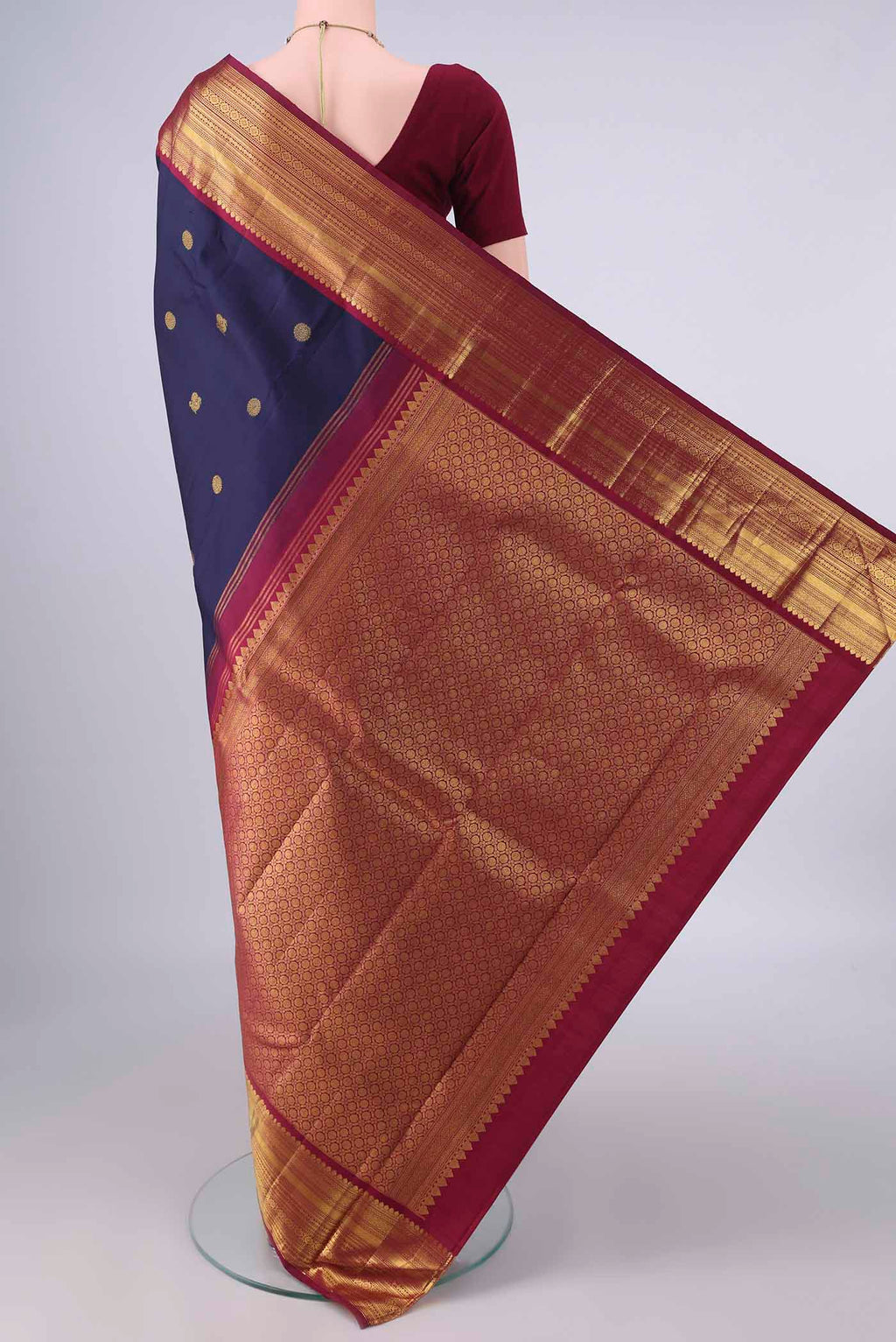 Flat view of Pure Silk Navy Blue Kanjivaram Saree with Zari Butta on the body and Zari Border. 