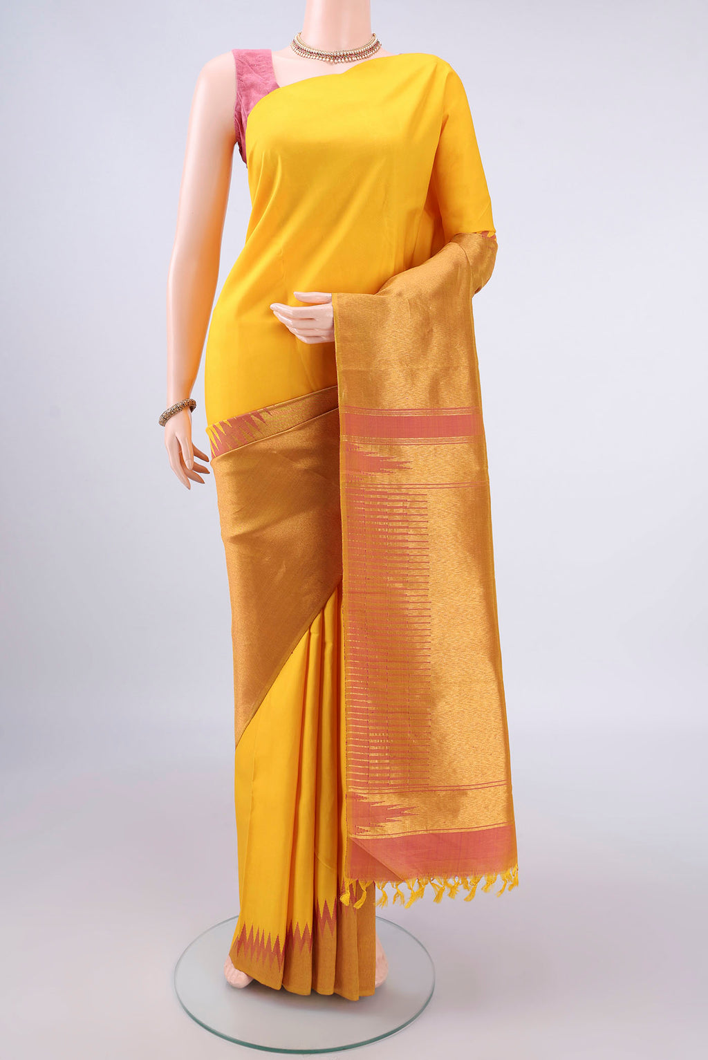 Pure Silk Yellow Kanjivaram Saree with Plain Body and Rising Temple Border.  displayed on a mannequin