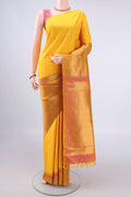 Pure Silk Yellow Kanjivaram Saree with Plain Body and Rising Temple Border.  displayed on a mannequin