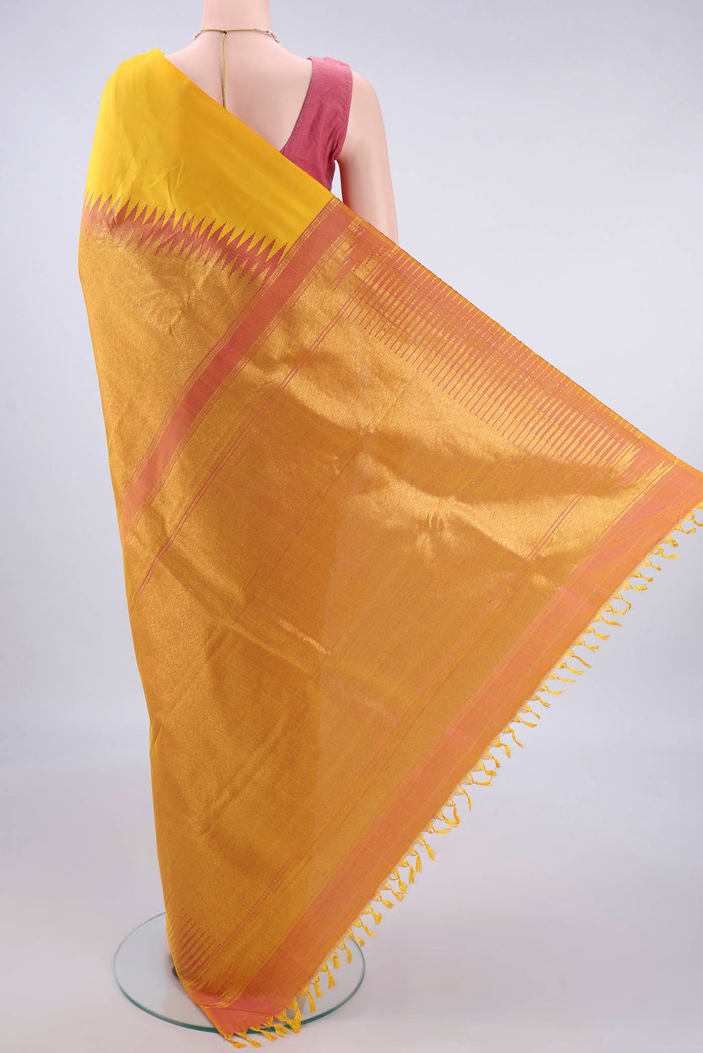 Flat view of Pure Silk Yellow Kanjivaram Saree with Plain Body and Rising Temple Border. 