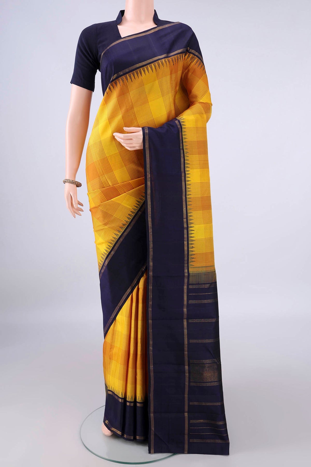 Pure Silk Yellow Kanjivaram Saree with Checked design on the body and Zari Border.  displayed on a mannequin