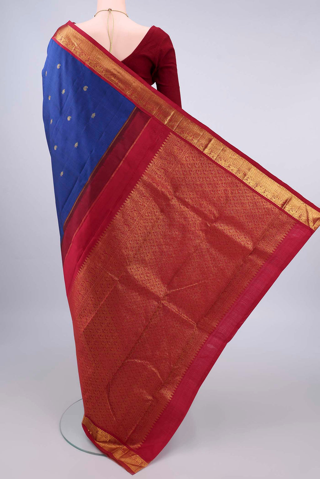 Flat view of Pure Silk Dark Blue Kanjivaram Saree with Zari Butta on the body and Zari Border. 