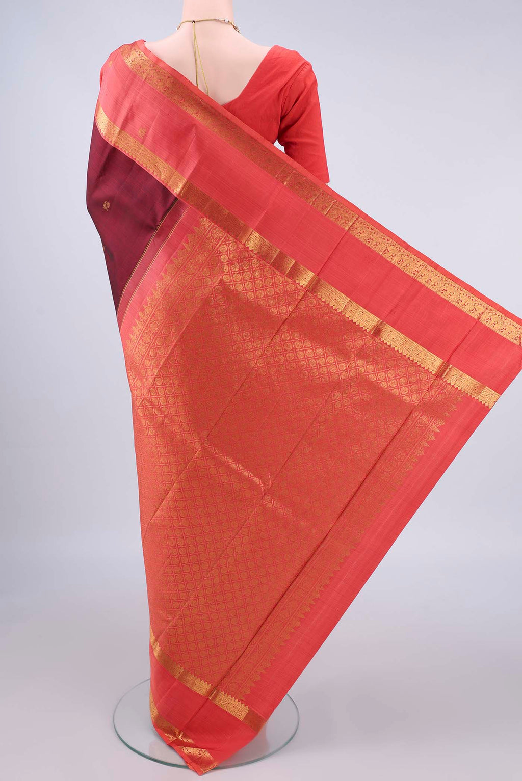 Flat view of Pure Silk Maroon Kanjivaram Saree with Zari Butta on the body and Zari Border. 