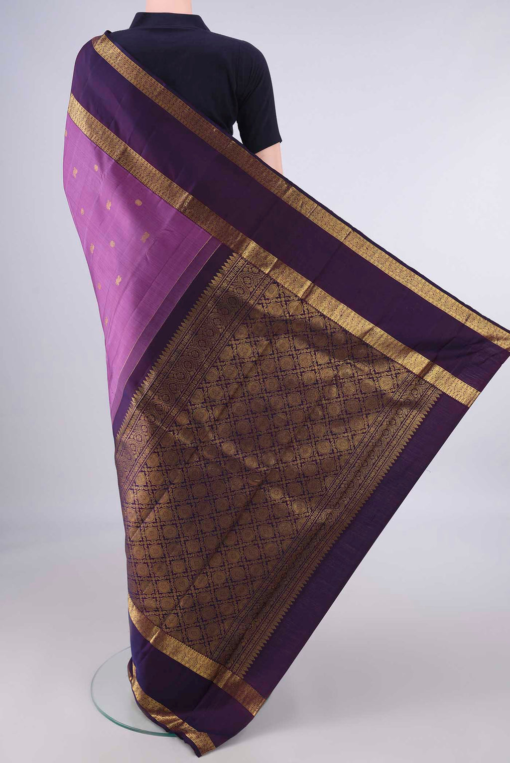 Flat view of Pure Silk Light Magenta Kanjivaram Saree with Zari Butta on the body and Zari Border. 