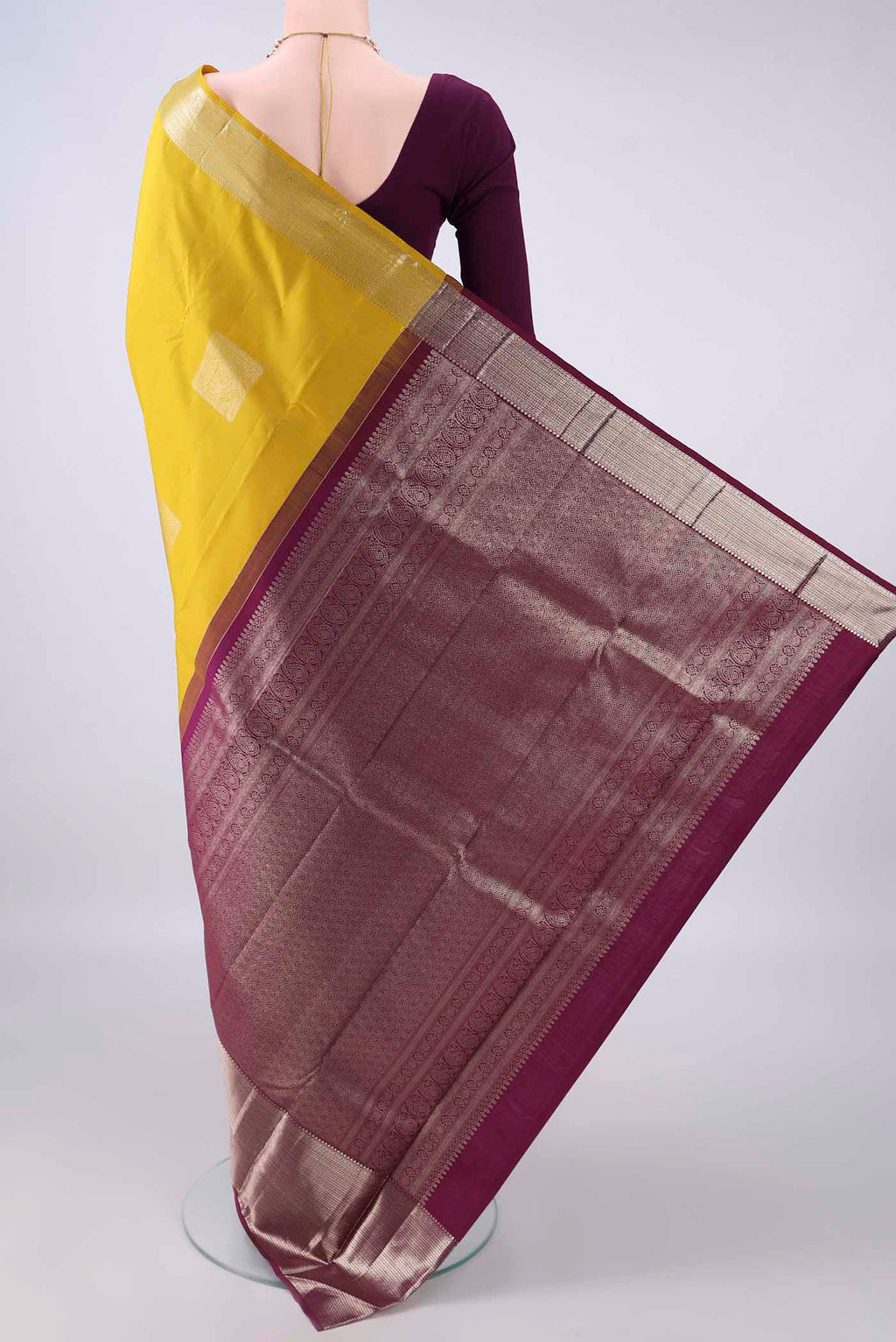 Flat view of Pure Silk Mustard Kanjivaram Saree with Plain Body and Zari Border. 