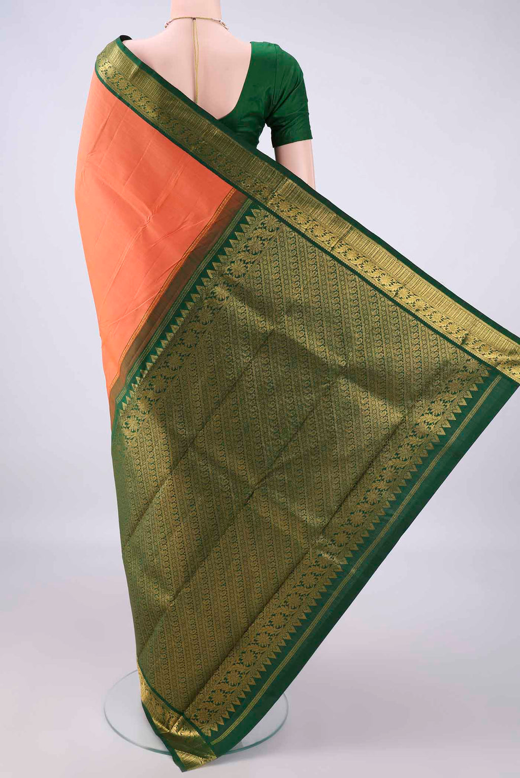 Flat view of Pure Silk Brick Orange Kanjivaram Saree with Plain Body and Zari Border. 