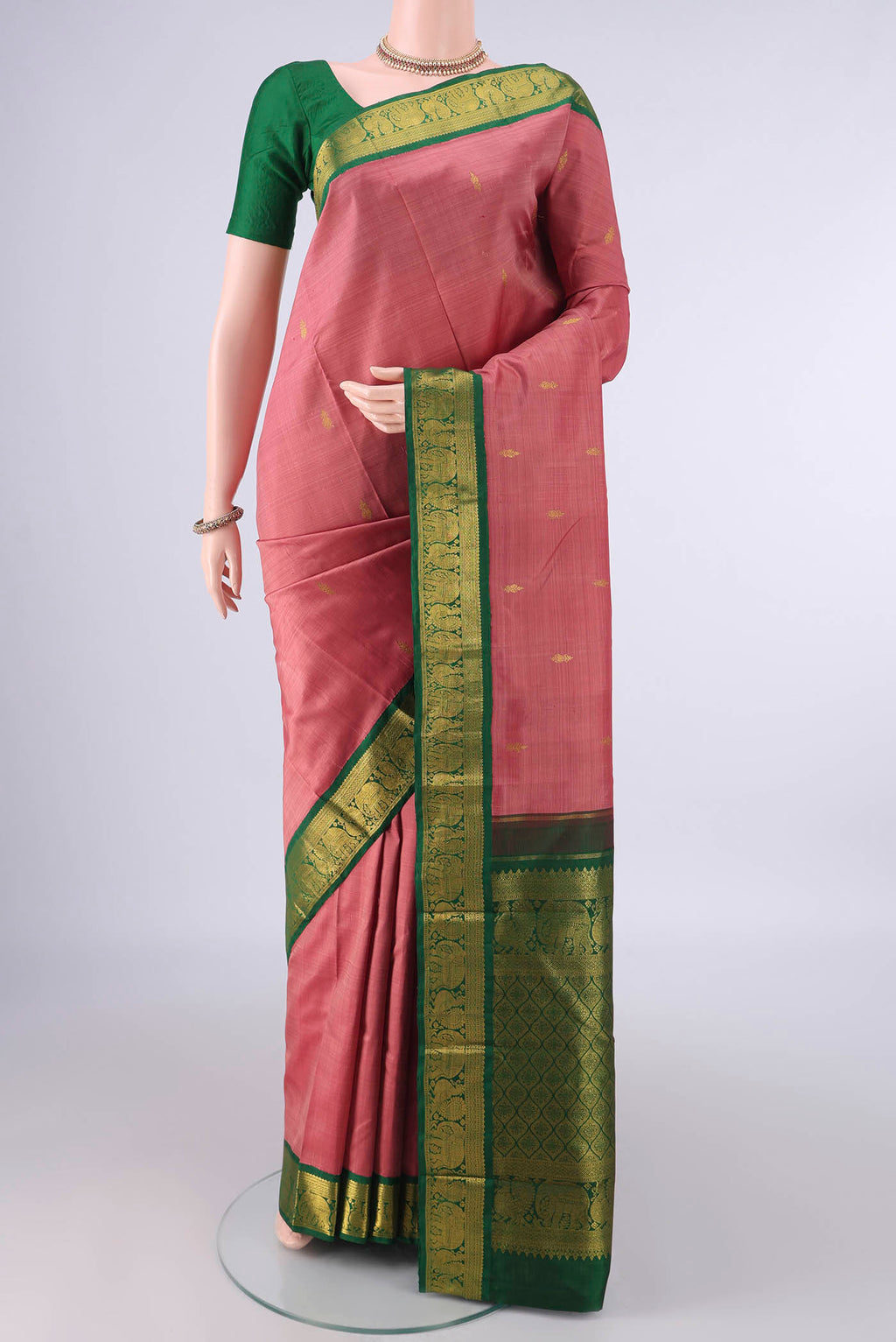 Pure Silk Coral Dual Tone Kanjivaram Saree with Zari Butta on the body and Zari Border.  displayed on a mannequin