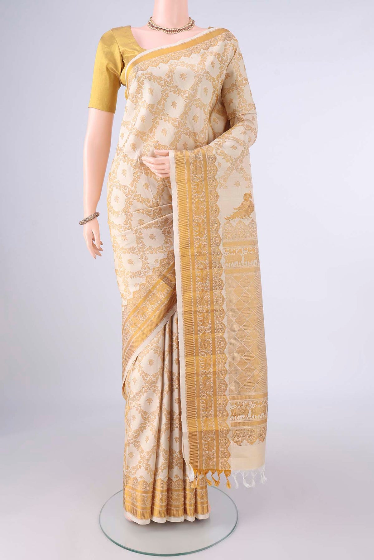 Pure Silk Cream Kanjivaram Saree with Thread Brocade on the body and Thread Border.  displayed on a mannequin