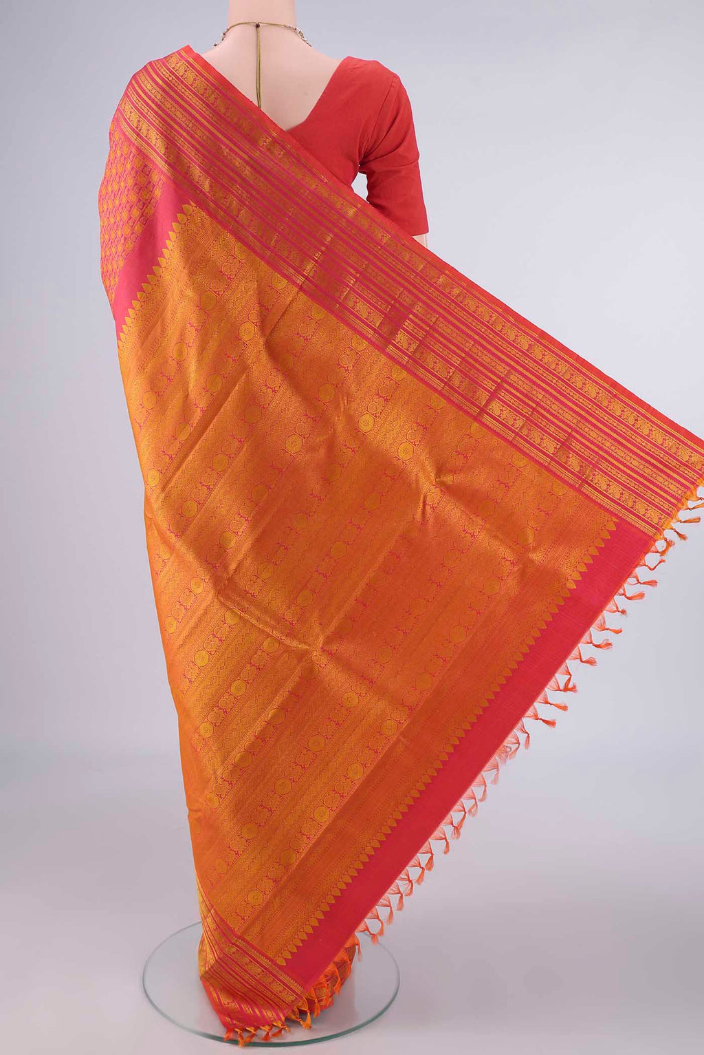 Flat view of Pure Silk Brick Orange Kanjivaram Saree with Jacquard design on the body and Thread Border. 