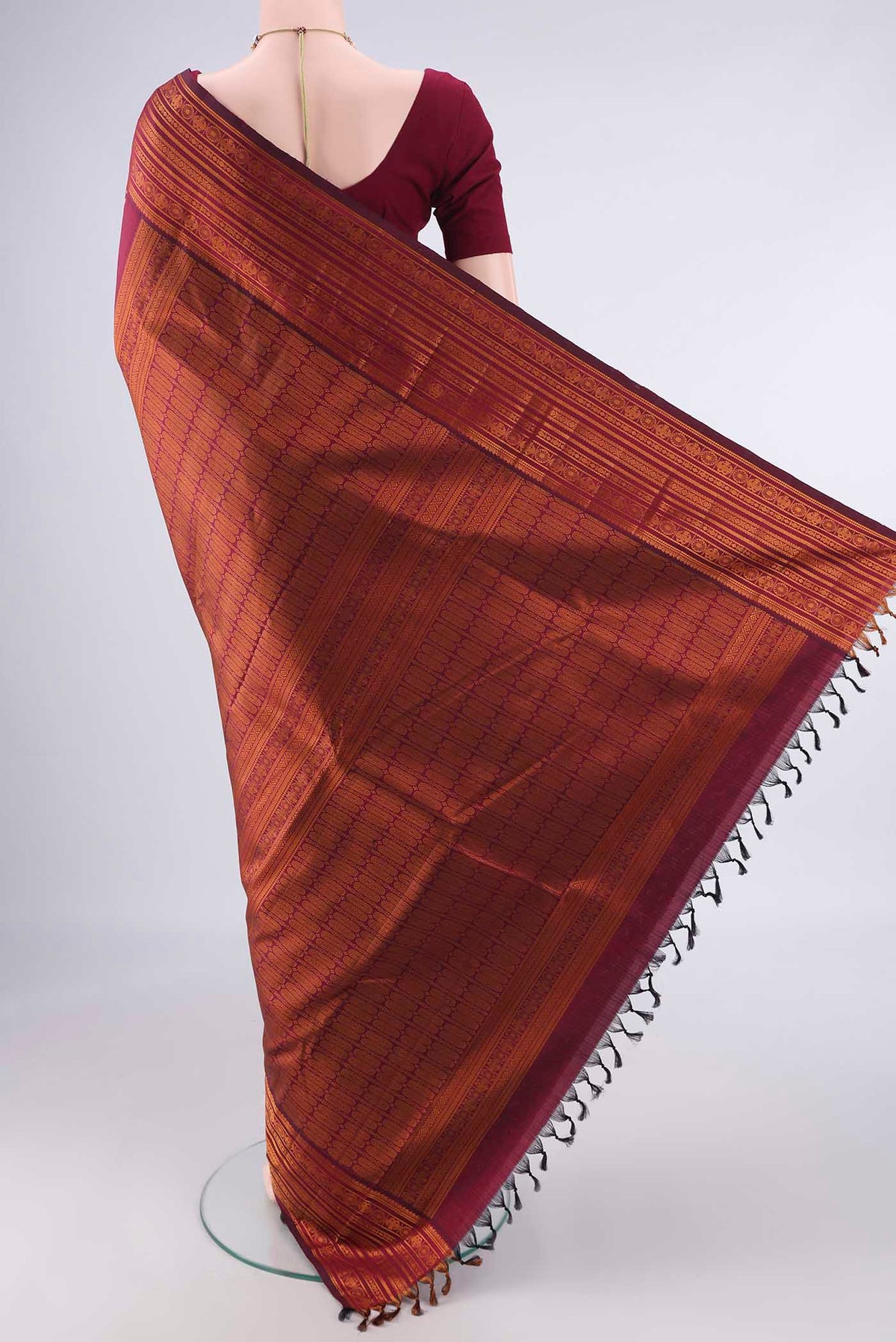 Flat view of Pure Silk Maroon Kanjivaram Saree with Jacquard design on the body and Thread Border. 