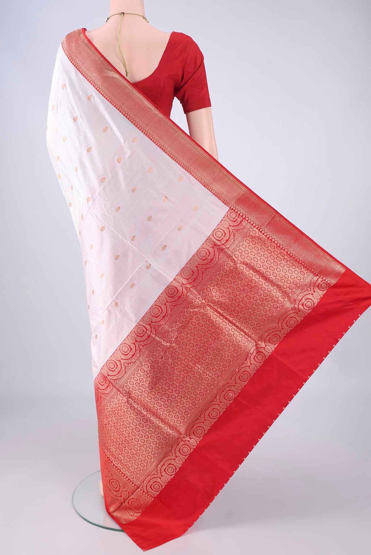Flat view of White Banarasi Katan Silk Saree with Zari Butta on the body and Zari Border. 