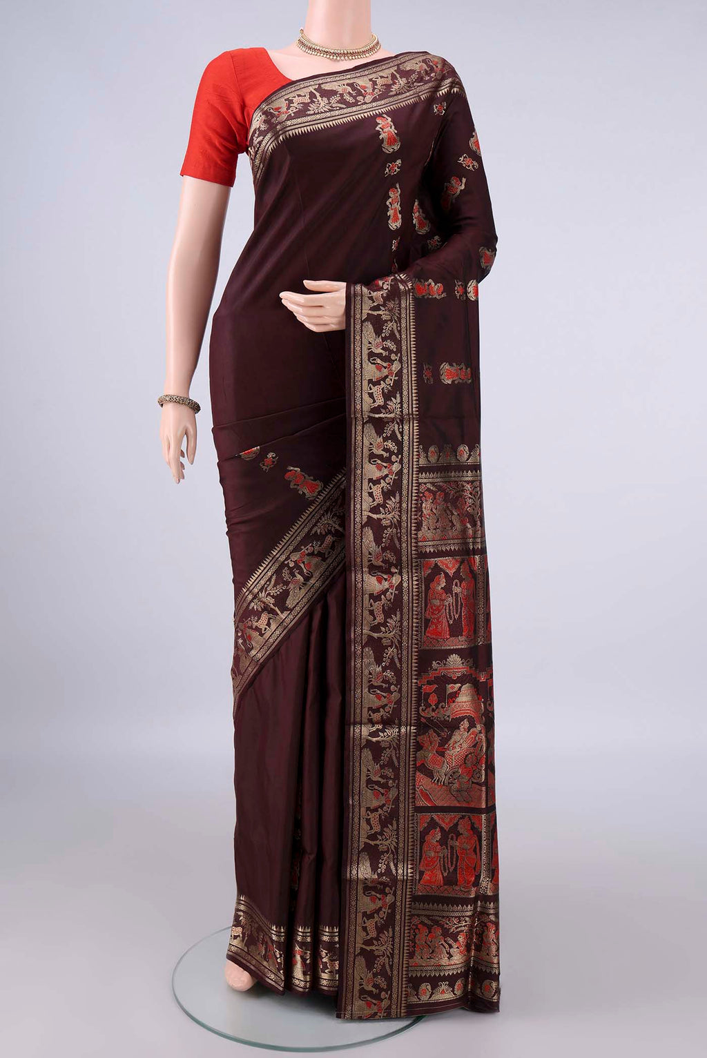 Pure Silk Coffee Brown Baluchari Saree with Zari And Thread Butta on the body and Zari Border.  displayed on a mannequin