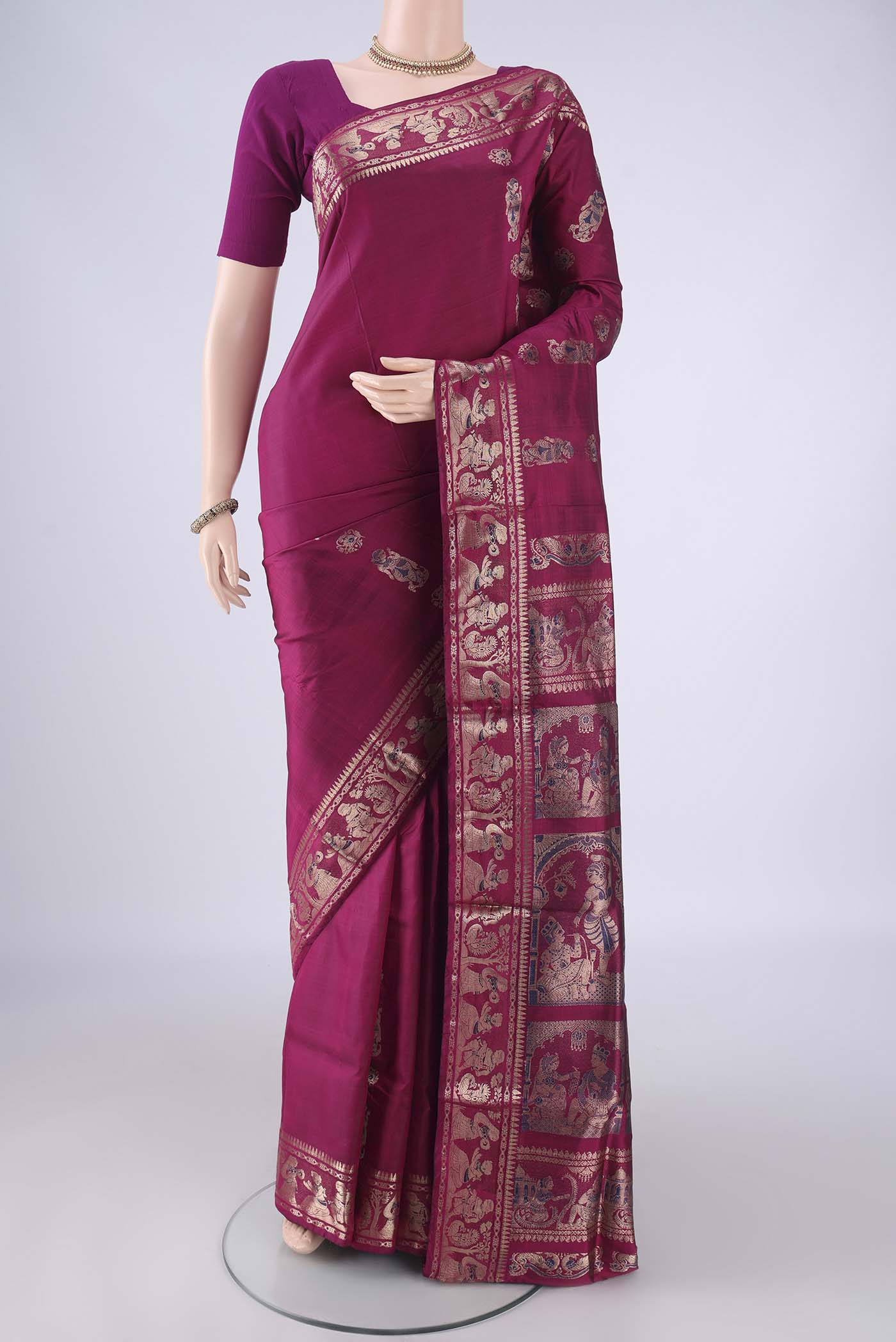 Magenta Baluchari Silk Saree with Zari And Thread Butta on the body and Zari And Thread Border.  displayed on a mannequin