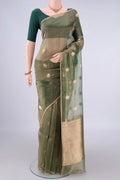Green Organza Saree with Zari Butta on the body and Zari Border.  displayed on a mannequin