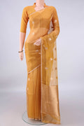 Golden Organza Saree with Zari Butta on the body and Thin Zari Line.  displayed on a mannequin